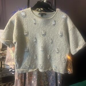 Gray shirt with trinkets